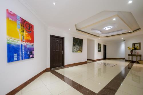 a hallway with a door and paintings on the walls at Hotel Rudi in Nairobi