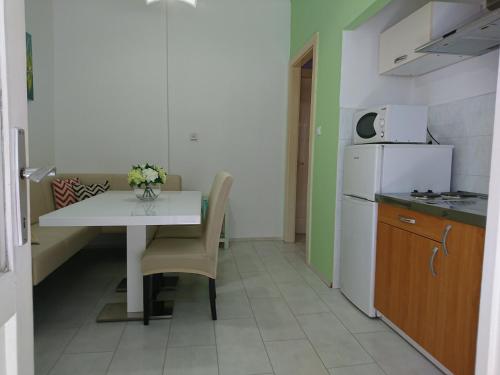 a small kitchen with a table and a refrigerator at Apartment Spalatina in Split