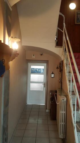 a hallway with a white door and a staircase at Locazione Turistica Antica dimora di Campagna in Grazzano Badoglio