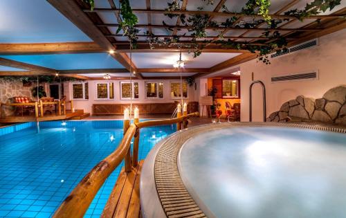a swimming pool in a house with a swimming pool at Villa Medici Hotel & Restaurant in Veszprém