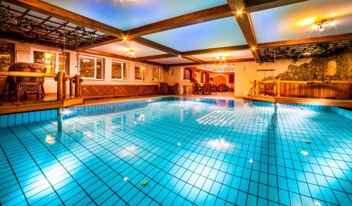 a large swimming pool in a house at Villa Medici Hotel & Restaurant in Veszprém