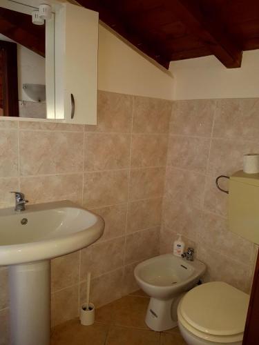 a bathroom with a sink and a toilet at San polo house in Parma