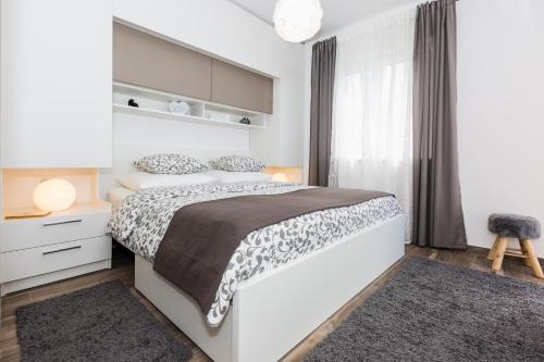 מיטה או מיטות בחדר ב-Villa Pergola-Apartment Toni