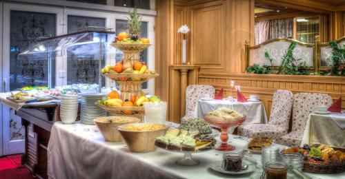a table topped with plates and bowls of food at Villa Medici Hotel & Restaurant in Veszprém