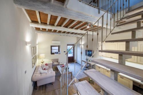 a living room with a couch and a table at Borgo Argiano in Castelnuovo Berardenga