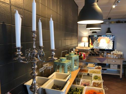 a counter with some candles and some food on it at Jennys Hotell och Restaurang in Arvika