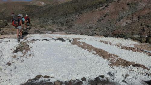 two people walking on a snow covered mountain at Auberge Amazigh in Tamtetoucht