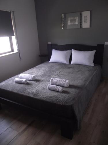 a bedroom with a bed with two towels on it at "A Casa dos Avôs" Suites & Breakfast in Lagos