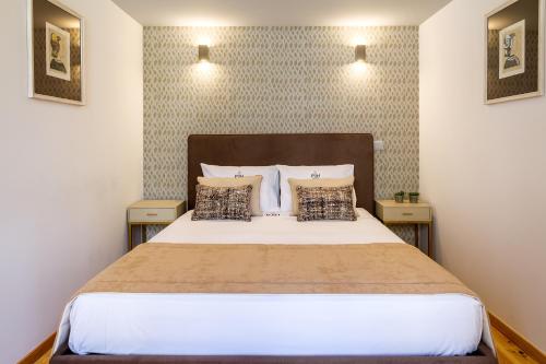 a bedroom with a large bed with two night stands at Formosa 178 by Guestify in Porto
