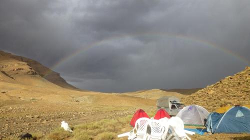 a group of tents with a rainbow in the background at Auberge Amazigh in Tamtetoucht