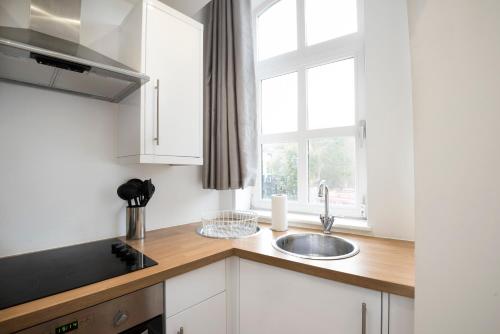 a kitchen with a sink and a window at StayInn Old Street in London