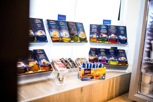 a store shelf with a display of food and drinks at Hotel Touring in Carpi