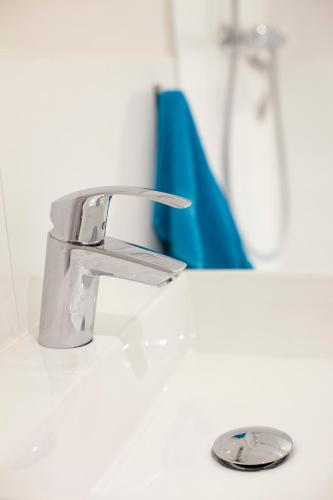 a bathroom sink with a chrome water faucet at Kuwadro Guesthouse Centrum in Amsterdam