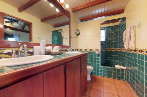 a bathroom with two sinks and a toilet and a shower at Condo #22 @ Beachside Villas in Seine Bight Village