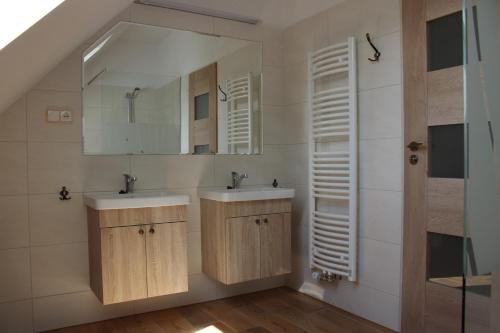 ein Badezimmer mit 2 Waschbecken und einem Spiegel in der Unterkunft Apartmány Loučná nad Desnou in Loučná nad Desnou