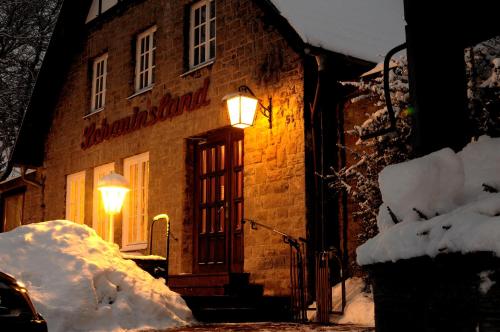 a brick building with a light on the door at Hotel-Café "Schauinsland" in Horn-Bad Meinberg
