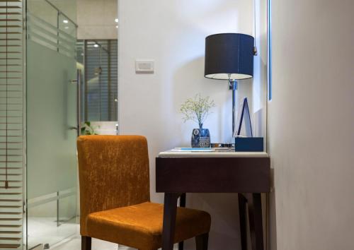 a desk with a chair and a lamp in a room at Hanoi Brilliant Hotel & Spa in Hanoi
