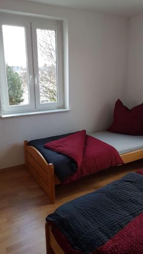 a bedroom with a bed and a window at Ferienwohnung am Hang in Ettenheim