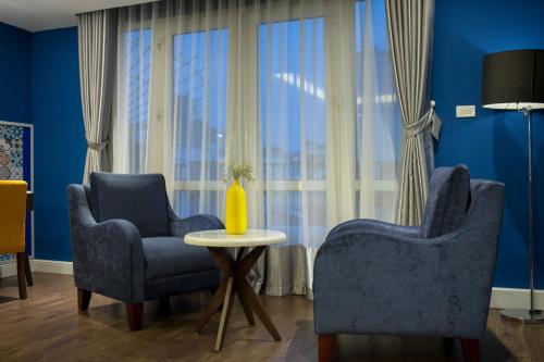 a living room with two chairs and a table at Hanoi Brilliant Hotel & Spa in Hanoi