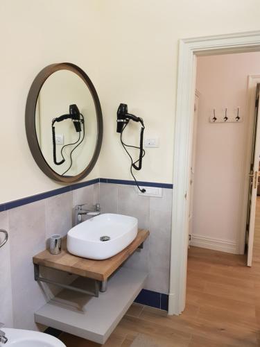 a bathroom with a sink and a mirror on the wall at Al centro Luxury Home in Caserta