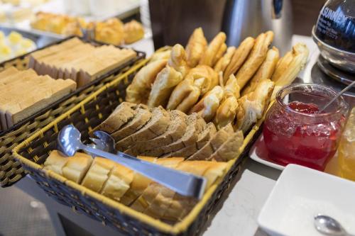 a tray of bread and crackers and other food on a table at Hanoi Brilliant Hotel & Spa in Hanoi