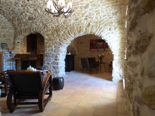 an archway in a stone building with a table and chairs at Mas d'Asvin & Spa in Saint-Christol-lès-Alès