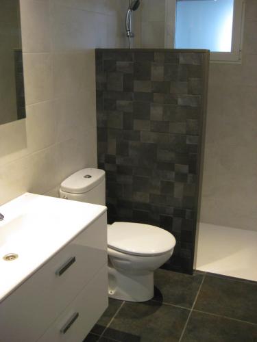 a bathroom with a toilet and a sink and a shower at Hello Oliva Beach BB in Oliva