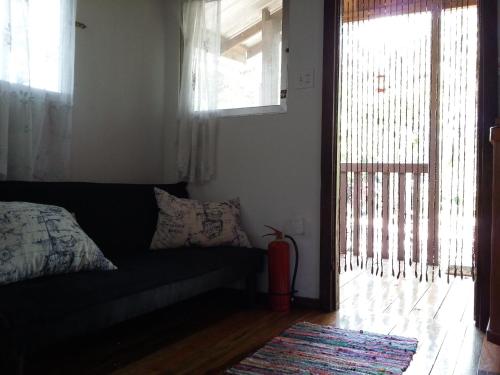 a living room with a couch and a window at Hidden Haven in Unitedville