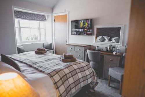 a bedroom with a bed with two brown towels on it at Kings Arms in Penzance