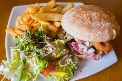 a sandwich and a salad and french fries on a plate at Kings Arms in Penzance