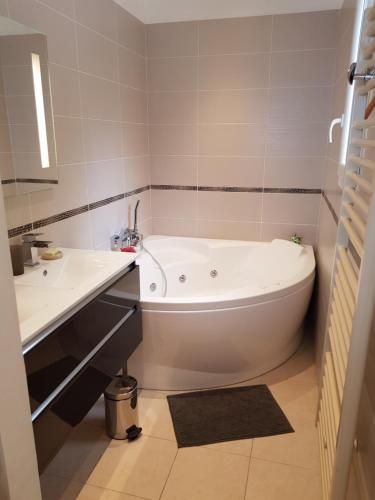 a bathroom with a white tub and a sink at Vue mer.Tranquilité.Cap d'Ail à 10 mn de MONACO in Cap d'Ail