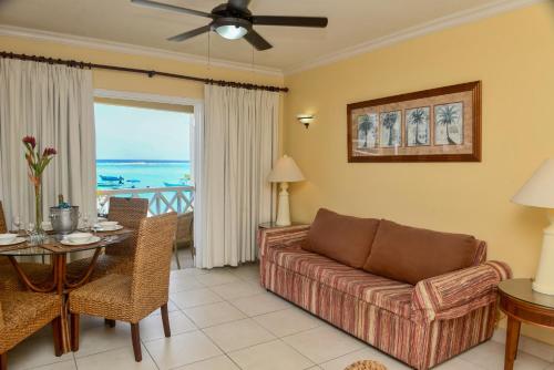 a living room with a couch and a table at Yellow Bird Hotel in Christ Church