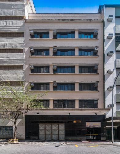 a tall building with a parking garage in front of it at Soneca Plaza Hotel in Sao Paulo