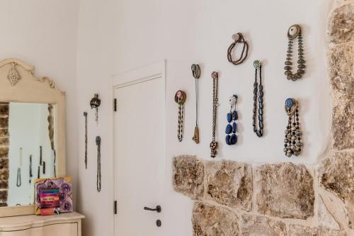 a wall with many different types ofhelmets hanging on a wall at Itaca Home to Explorers in Polignano a mare in Polignano a Mare