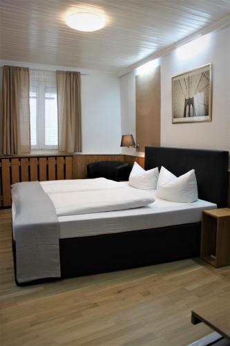 a bedroom with a large bed in a room at Hotel Krone in Pfullendorf