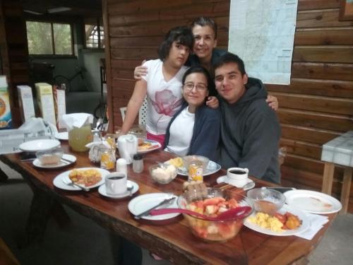 a group of people sitting at a table with food at Hidden Haven in Unitedville
