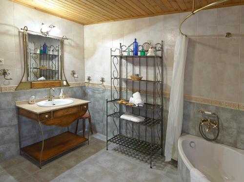 a bathroom with a sink and a tub and a shower at Casa Samuel in Navia
