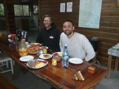 two men sitting at a table with food on it at Hidden Haven in Unitedville