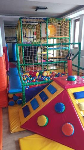 a childrens play room with a play set and a play room with a play at Milmari M18 Kopaonik in Kopaonik