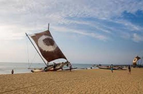 a large kite on a sandy beach on the beach at Angel villa in Negombo