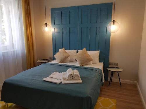 a bedroom with a bed with towels on it at Ditlin in Pápa
