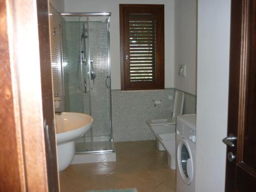 a bathroom with a shower and a sink and a toilet at Casa vacanze da Anna in Tortolì