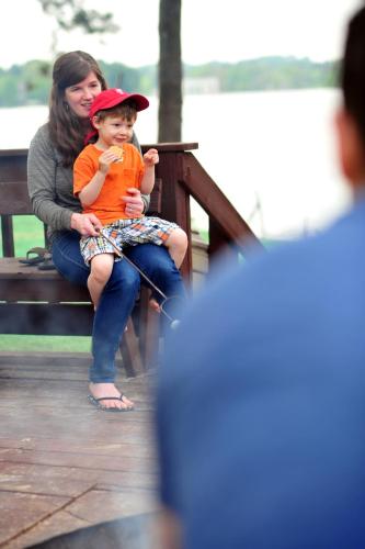 a woman and a child sitting on a bench at Sunset Bay Resort in Wisconsin Dells