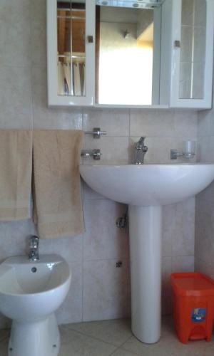 a bathroom with a white sink and a toilet at Villa Belvedere in Nardò