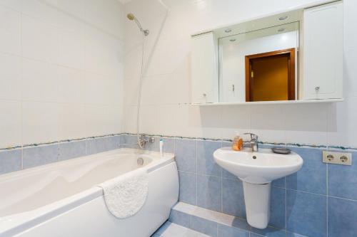 a bathroom with a white tub and a sink at Apartment in Complex Korona on Knyazhyi Zaton 21 in Kyiv