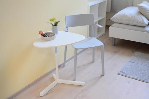 a white table and a chair in a room at Hostel Bratislava in Bratislava