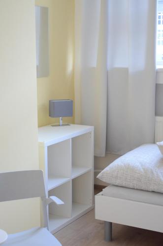 a bedroom with a bed and a white dresser at Hostel Bratislava in Bratislava
