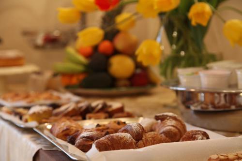 a table topped with different types of pastries on a table at Hotel Medici in Milazzo