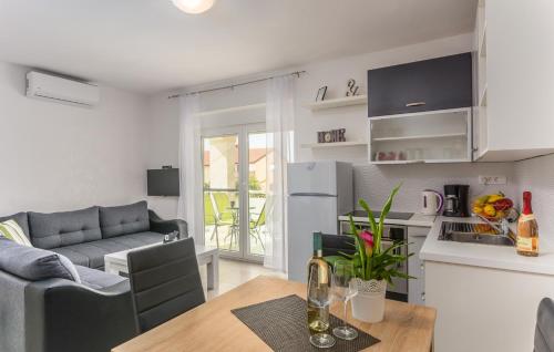 a kitchen and living room with a couch and a table at Villa Stephany in Poreč