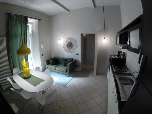 a kitchen and living room with a couch and a table at Doma 4.2 in Riccione